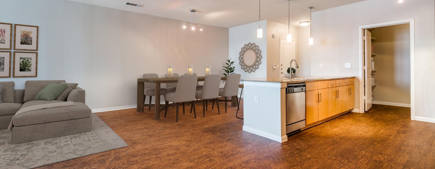 a large living room with a dining table and chairs