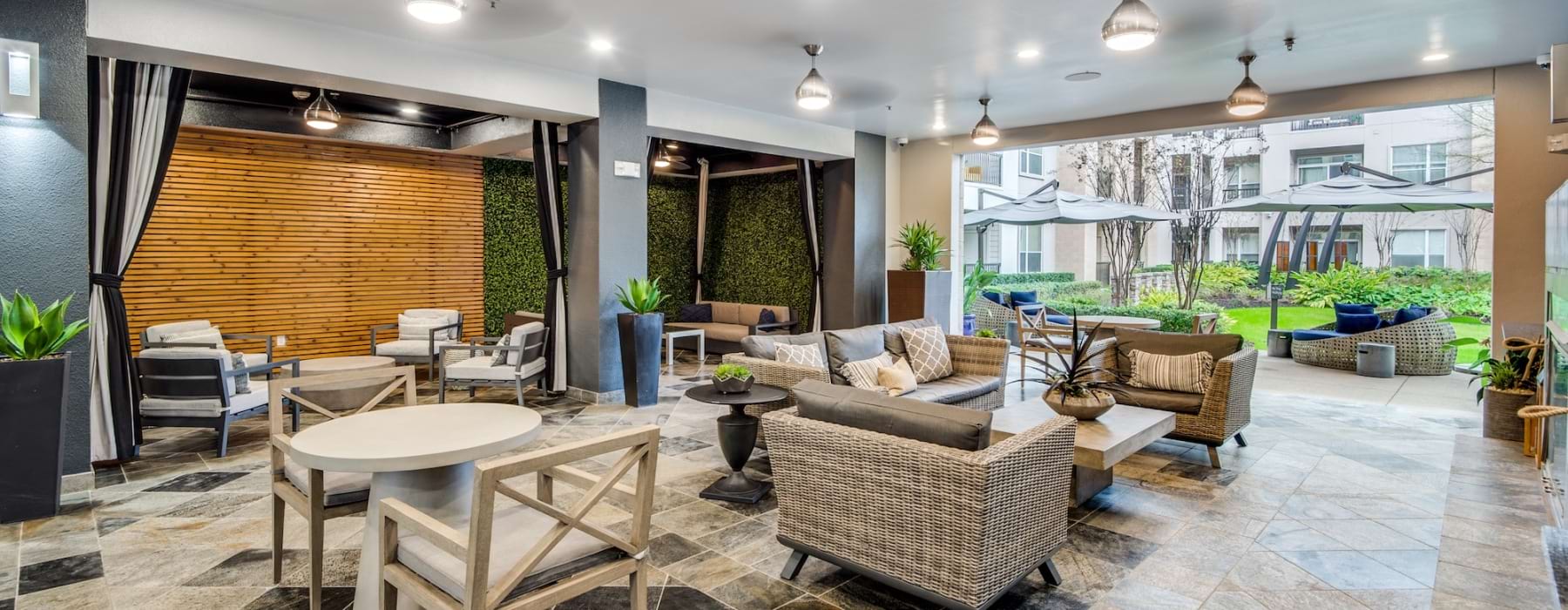 large room with couches chairs and a large bay door