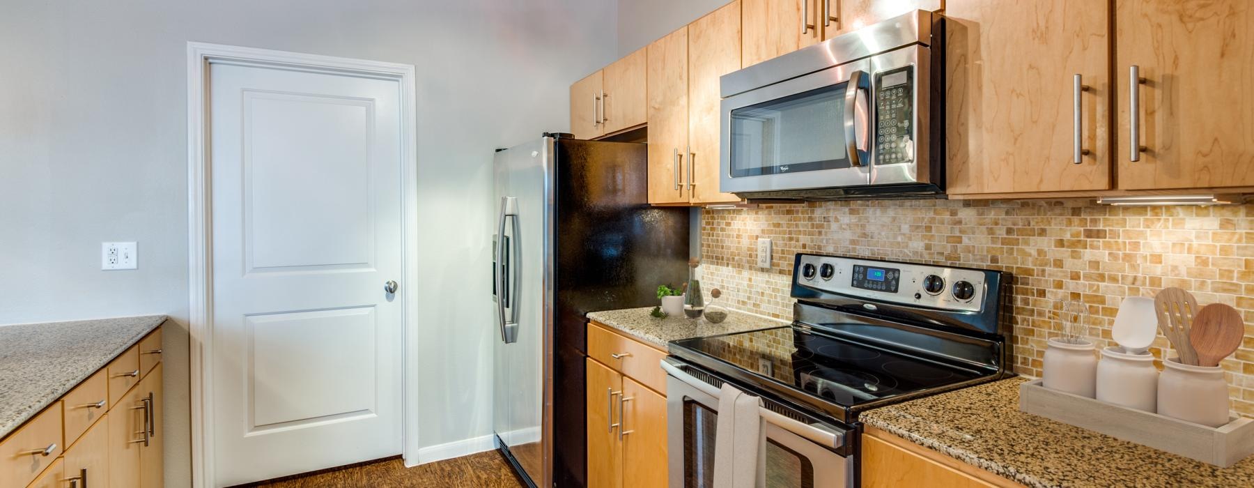 a kitchen with wooden cabinets